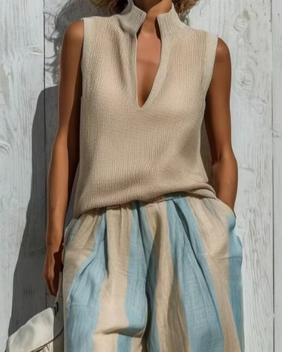 Alba completo — dettaglio del top smanicato con scollo a V e collo alto